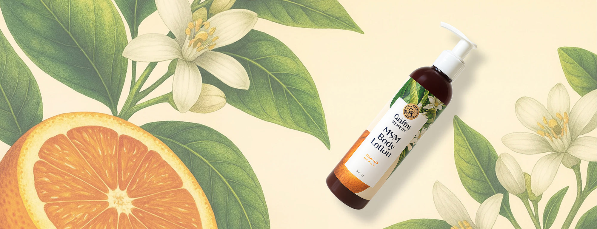 Bottle of lemon lotion with orange slices and flowers on a beige background