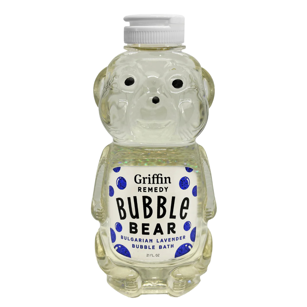 A bottle designed to resemble a bear, labeled 'Griffin Remedy Bubble Bear Bulgarian Lavender Bubble Bath', filled with a translucent liquid. Natural skincare.