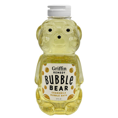 A bottle designed to look like a bear, filled with yellow bubble bath, labeled as 'Griffin Remedy Bubble Bear Chamomile Bubble Bath'. Natural skincare.