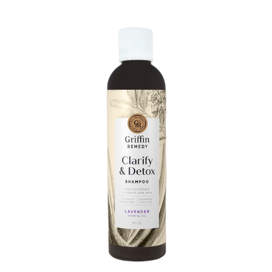 A bottle of Griffin Remedy Clarify & Detox Shampoo with a label featuring botanical illustrations and text indicating the product is lavender scented. Natural hair care.