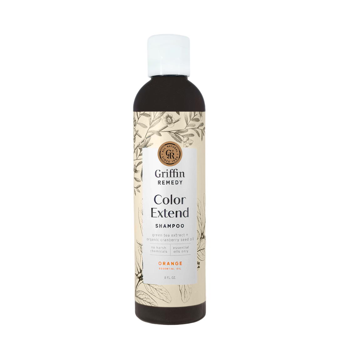 A bottle of Griffin Remedy Color Extend Shampoo with a label featuring botanical illustrations and text indicating the product name and scent. Natural hair care.