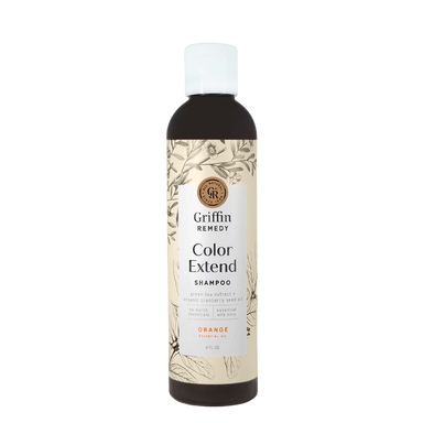 A bottle of Griffin Remedy Color Extend Shampoo with a label featuring botanical illustrations and text indicating the product name and scent. Natural hair care.