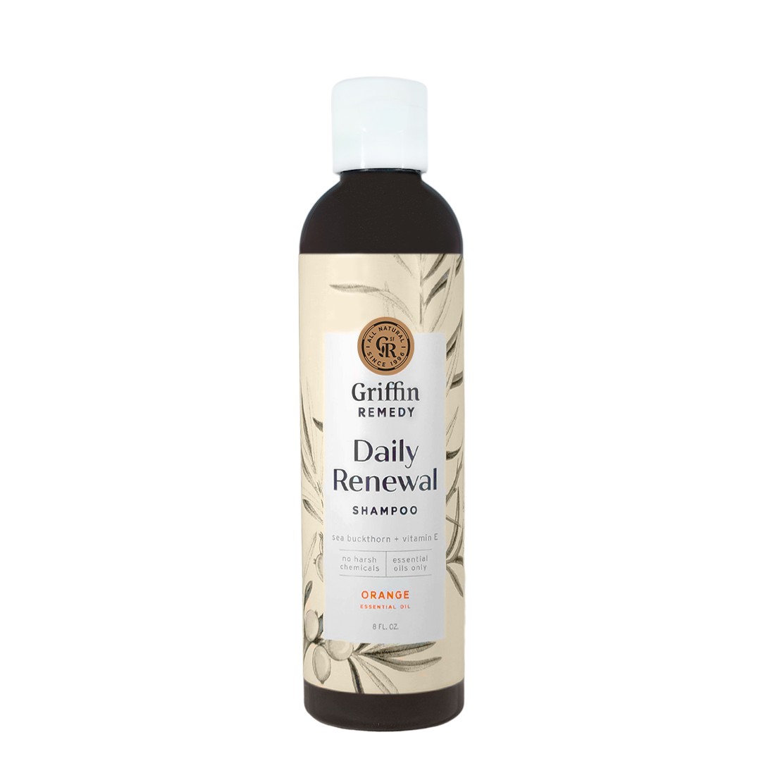 A bottle of Griffin Remedy Daily Renewal Shampoo with a label featuring botanical illustrations and the scent marked as Orange. Natural hair care.