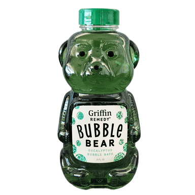 A plastic bottle shaped like a bear with a green label and eucalyptus leaves design, filled with a green bubble bath product. Natural skincare.