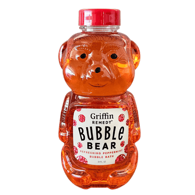 A plastic teddy bear-shaped bottle of Griffin Remedy Bubble Bear bubble bath, with a red cap and orange liquid inside. Natural skincare.