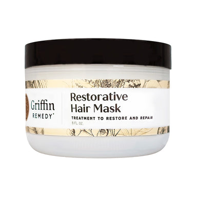 A white jar with a black lid labeled 'Griffin Remedy Restorative Hair Mask' with additional text stating it is a treatment to restore and repair hair. Natural hair care.