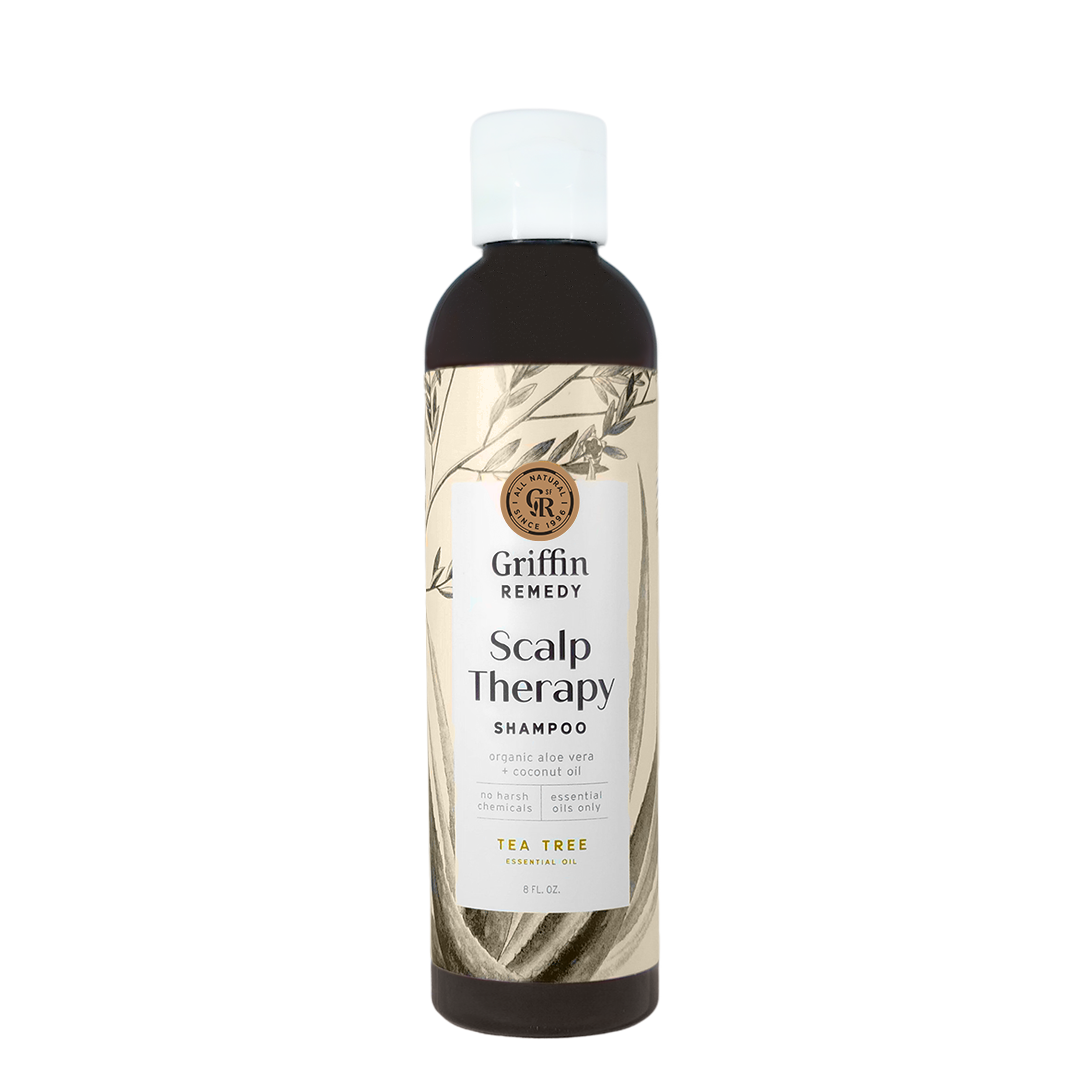 A bottle of Griffin Remedy Scalp Therapy Shampoo with a beige label featuring botanical illustrations. Natural hair care.