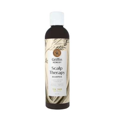 A bottle of Griffin Remedy Scalp Therapy Shampoo with a beige label featuring botanical illustrations. Natural hair care.