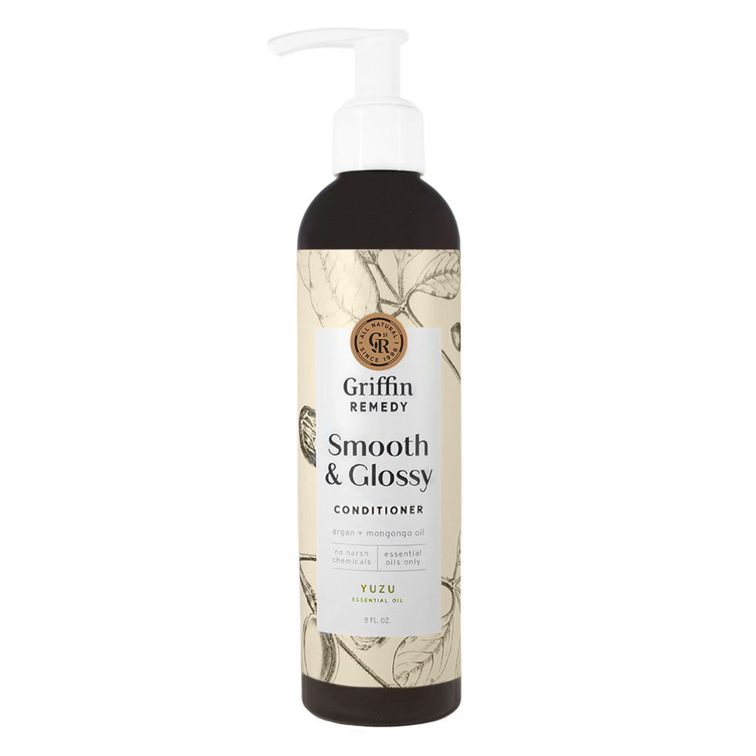 A pump bottle of Griffin Remedy Smooth & Glossy Conditioner with a label featuring botanical illustrations. Natural hair care.