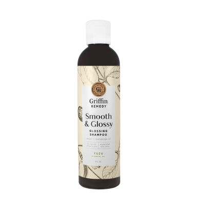 A bottle of Griffin Remedy Smooth & Glossy Shampoo with a label featuring botanical illustrations. Natural hair care.