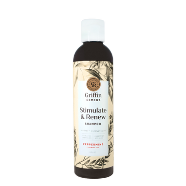 A bottle of Griffin Remedy Stimulate & Renew Shampoo with a label featuring botanical illustrations and text indicating the scent as Peppermint. Natural hair care.