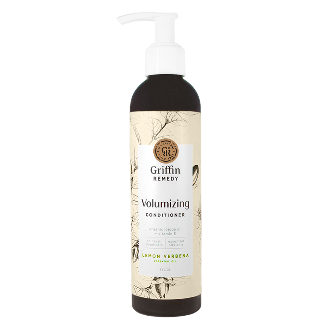 A pump bottle of Griffin Remedy Volumizing Conditioner with a label featuring botanical illustrations and text. Natural hair care.