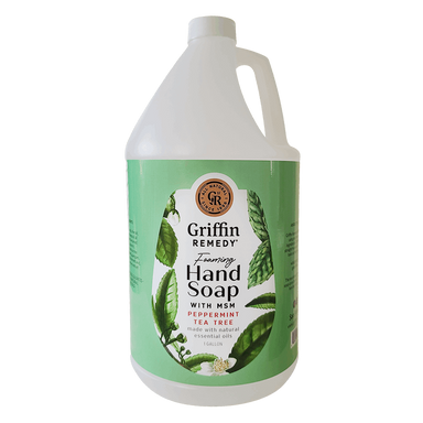A gallon-sized bottle of Griffin Remedy Foaming Hand Soap with peppermint tea tree essential oils. The label shows a green and white design with leaves and floral elements. Natural soap.