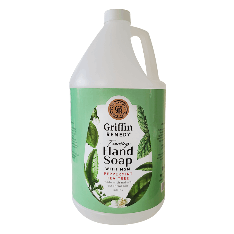 A gallon-sized bottle of Griffin Remedy Foaming Hand Soap with peppermint tea tree essential oils. The label shows a green and white design with leaves and floral elements. Natural soap.