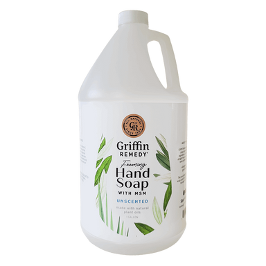 A gallon-sized container of Griffin Remedy Foaming Hand Soap with MSM, Unscented, featuring a white label with green leaf designs. Natural soap.