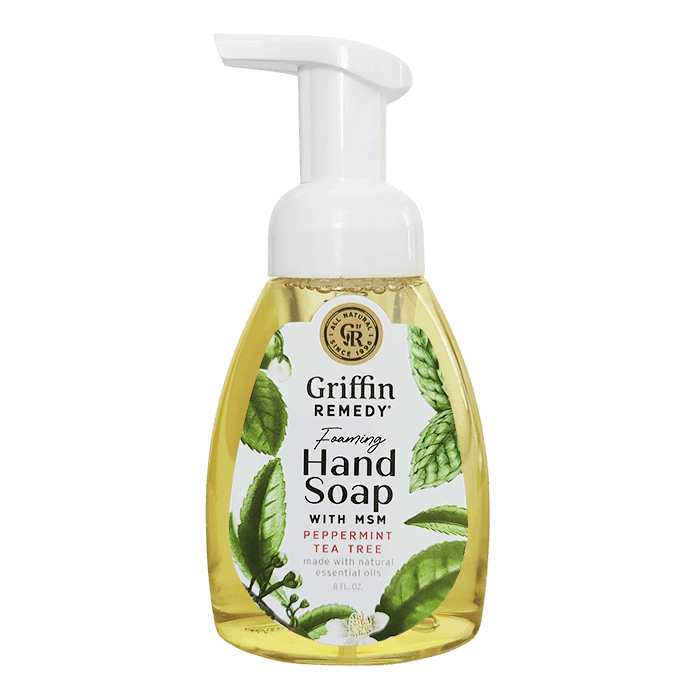 A pump bottle of Griffin Remedy Foaming Hand Soap with Peppermint Tea Tree. The label shows green and white colors with leaf patterns and the soap appears to be a clear liquid. Natural soap.
