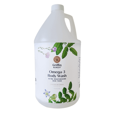 A gallon-sized container of Griffin Remedy Omega-3 Creamy Body Wash with a label featuring botanical illustrations and information about the product. Natural skincare.
