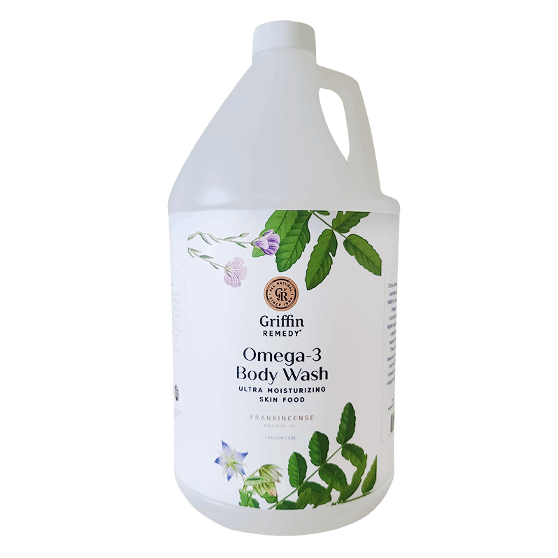 A gallon-sized container of Griffin Remedy Omega-3 Creamy Body Wash with a label featuring botanical illustrations and information about the product. Natural skincare.