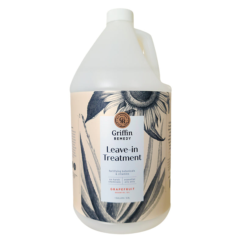 A gallon bottle of Griffin Remedy Leave-In Treatment with a label featuring botanical designs. Natural hair care.