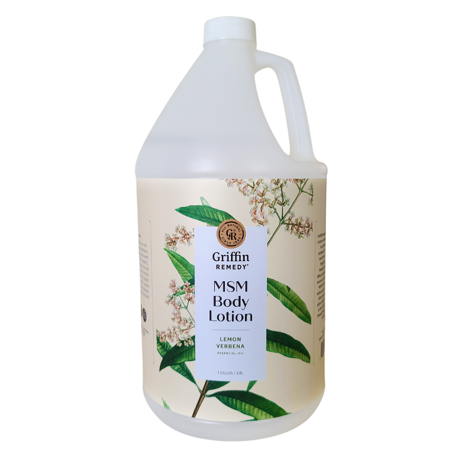 A gallon-sized bottle of Griffin Remedy MSM Body Lotion with Lemon Verbena fragrance. The bottle is white with a handle and a label featuring botanical illustrations. Natural skincare.