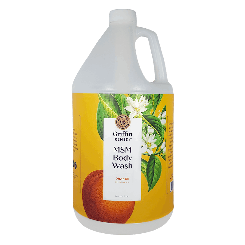 A gallon-sized bottle of Griffin Remedy MSM Body Wash with a label featuring an orange and orange blossoms. Natural skincare.
