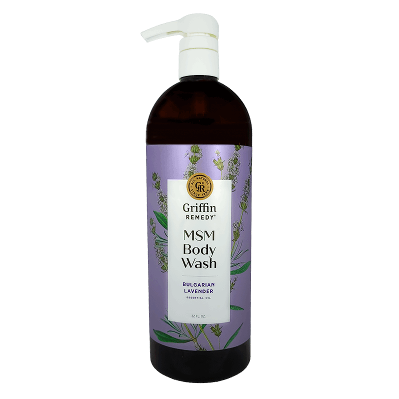 A clear bottle of Griffin Remedy MSM Body Wash with Bulgarian Lavender, labeled and with a visible purple hue to the liquid inside. Natural skincare.