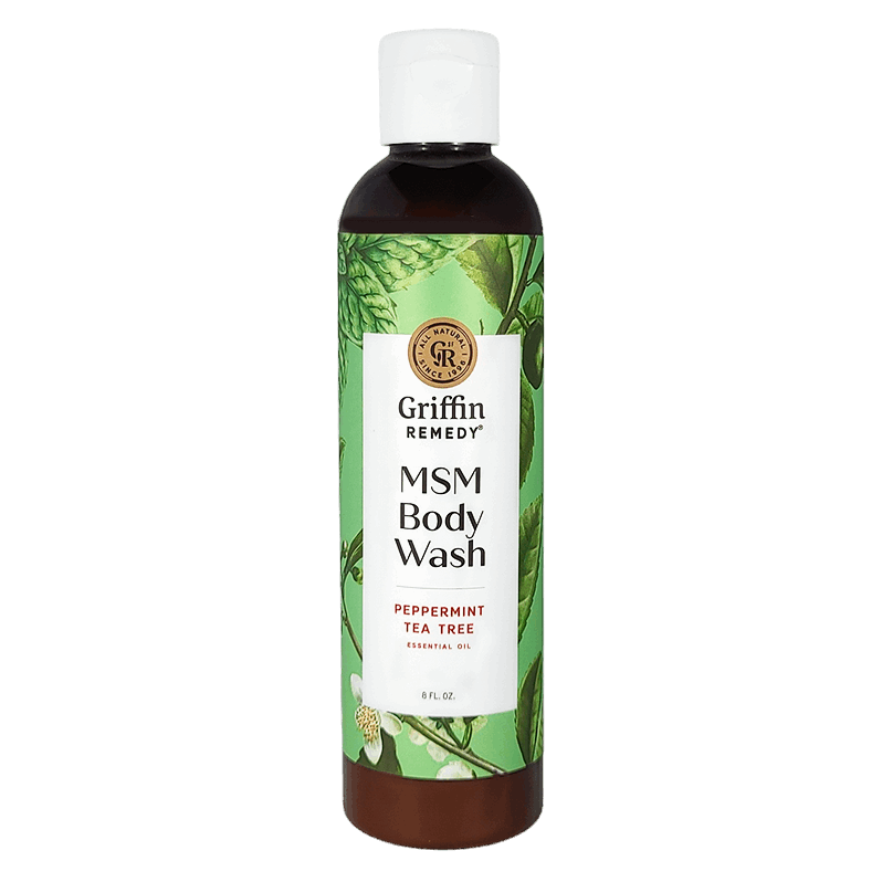 A bottle of Griffin Remedy MSM Body Wash with Peppermint Tea Tree. The label shows a green and white design with botanical elements and the product information. Natural skincare.