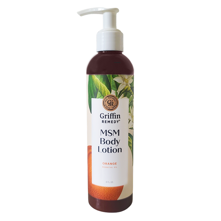 A pump bottle of Griffin Remedy MSM Body Lotion with Orange Blossom scent, featuring a label with orange flowers and product information. Natural skincare.