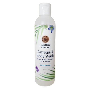 A bottle of Griffin Remedy Omega-3 Creamy Body Wash with a label that includes the product name and 'Unscented' beside it. The bottle is white with green and blue floral design accents. Natural skincare.