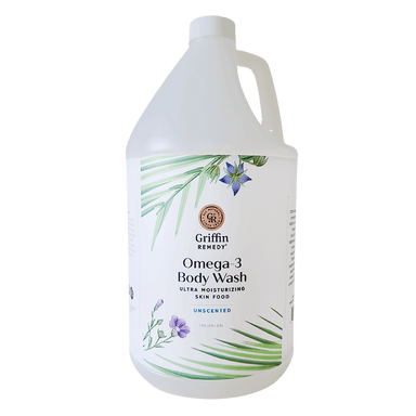 A gallon-sized bottle of Griffin Remedy Omega-3 Creamy Body Wash with a label featuring green leaves and flowers design. Natural skincare.