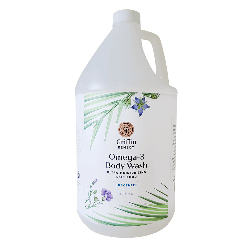 A gallon-sized bottle of Griffin Remedy Omega-3 Creamy Body Wash with a label featuring green leaves and flowers design. Natural skincare.