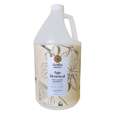 A gallon-sized bottle of Griffin Remedy Age Renewal Anti-Aging Shampoo with a floral design on the label. Natural hair care.