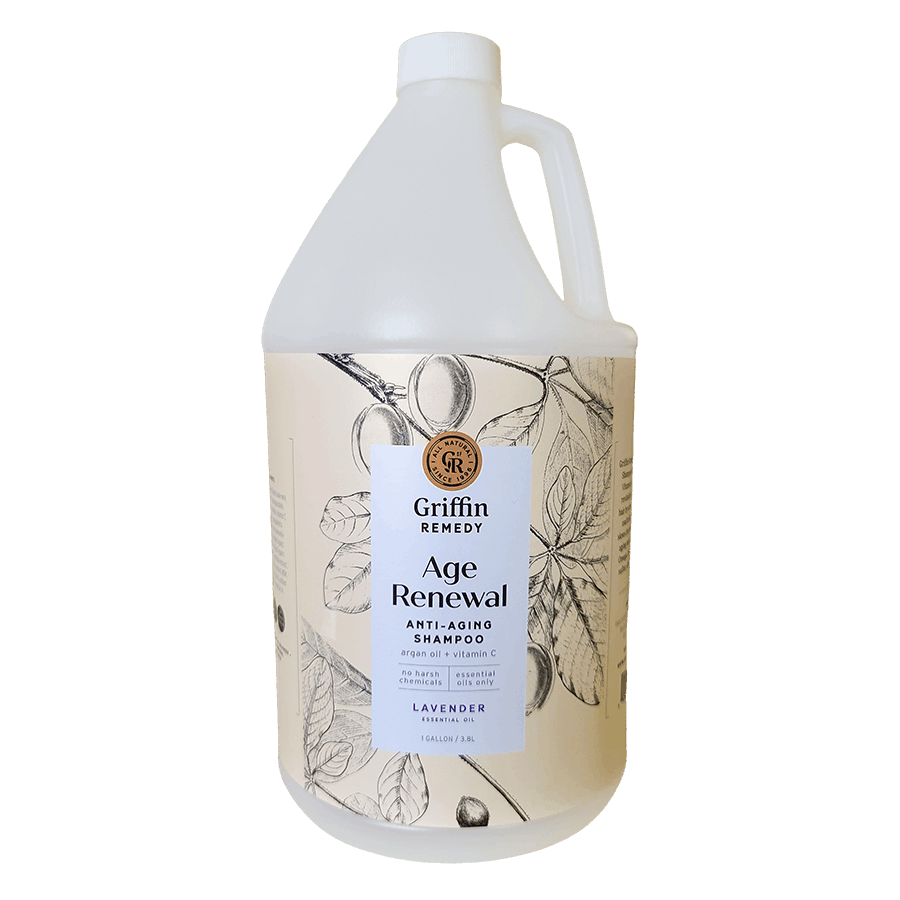 A gallon-sized bottle of Griffin Remedy Age Renewal Anti-Aging Shampoo with a floral design on the label. Natural hair care.