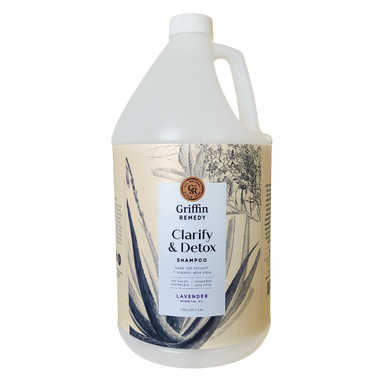 A gallon-sized bottle of Griffin Remedy Clarify & Detox Shampoo with a lavender scent, featuring a label with botanical illustrations. Natural hair care.