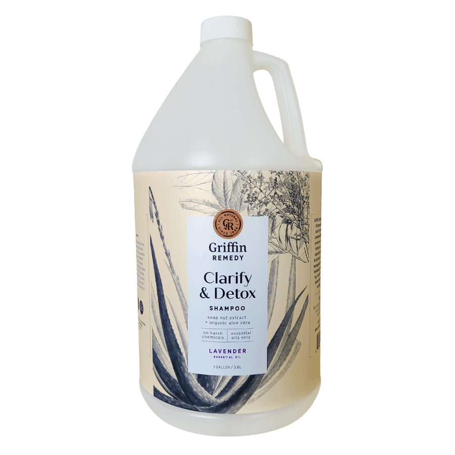 A gallon-sized bottle of Griffin Remedy Clarify & Detox Shampoo with a lavender scent, featuring a label with botanical illustrations. Natural hair care.
