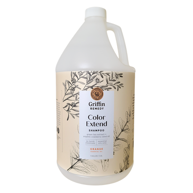 A gallon-sized bottle of Griffin Remedy Color Extend Shampoo with a floral pattern on the label and orange scent indicated on the front. Natural hair care.