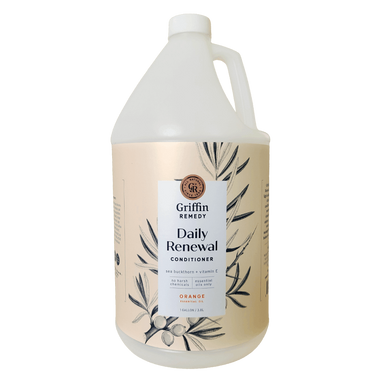 A gallon-sized container of Griffin Remedy Daily Renewal Conditioner with Sea Buckthorn & Orange, featuring a floral design on the label. Natural hair care.