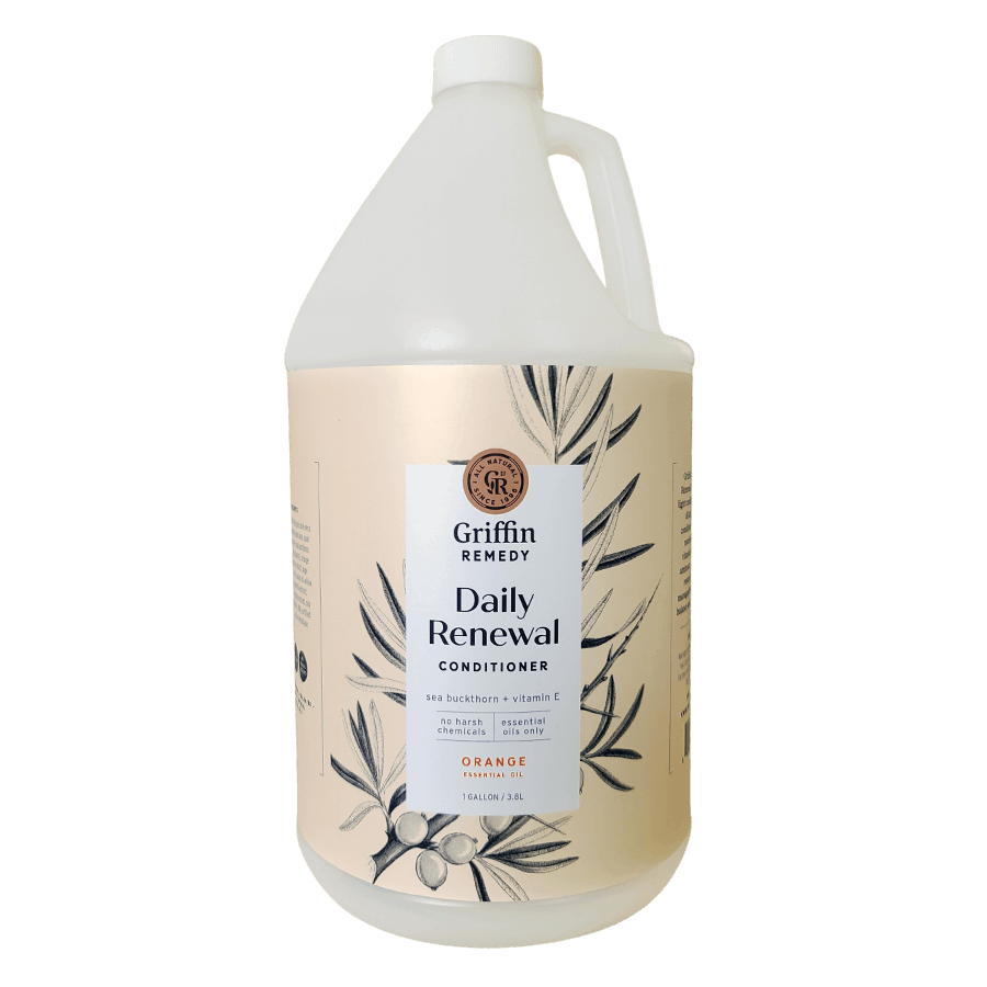 A gallon-sized container of Griffin Remedy Daily Renewal Conditioner with Sea Buckthorn & Orange, featuring a floral design on the label. Natural hair care.