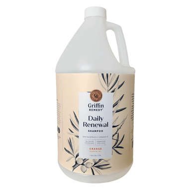 A gallon-sized bottle of Griffin Remedy Daily Renewal Shampoo with a label featuring botanical designs and text indicating the product name and scent. Natural hair care.