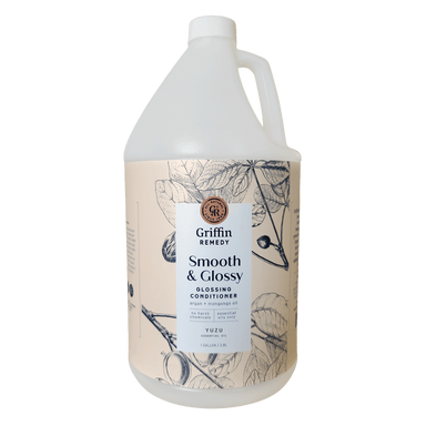A gallon bottle of Griffin Remedy Smooth & Glossy Conditioner with a label featuring botanical illustrations. Natural hair care.