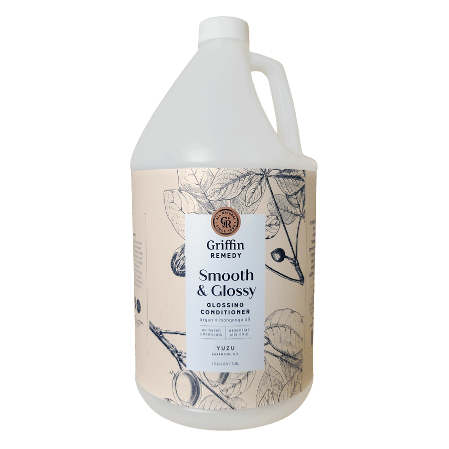 A gallon bottle of Griffin Remedy Smooth & Glossy Conditioner with a label featuring botanical illustrations. Natural hair care.