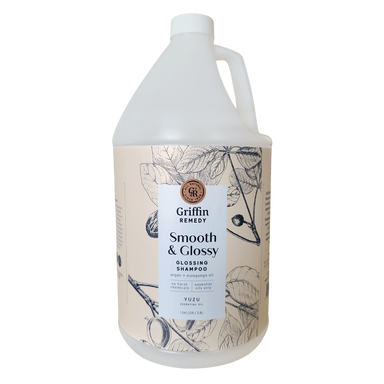 A gallon bottle of Griffin Remedy Smooth & Glossy Shampoo with a label featuring botanical illustrations. Natural hair care.