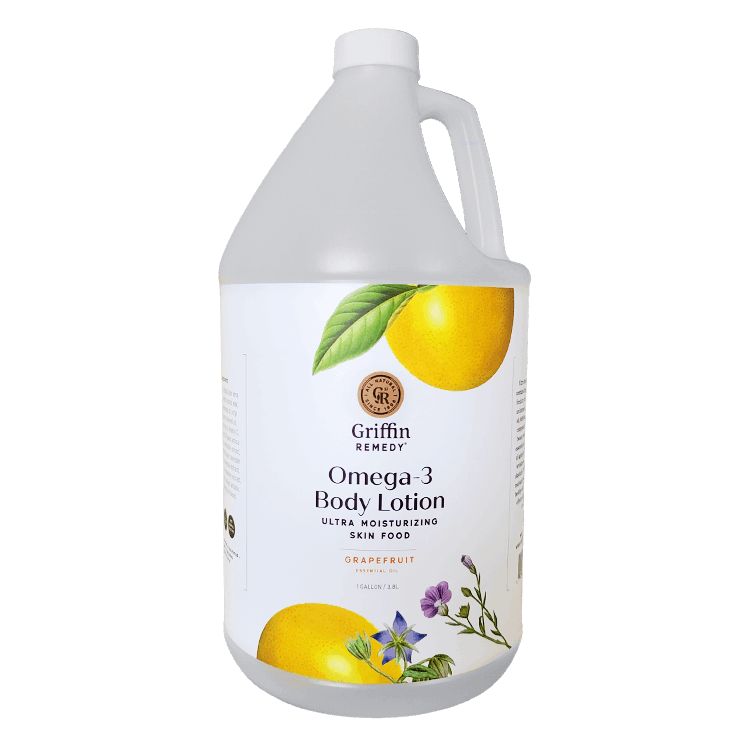 A gallon-sized bottle of Griffin Remedy Omega-3 Body Lotion with an image of a grapefruit on the label and various botanical illustrations. Natural skincare.