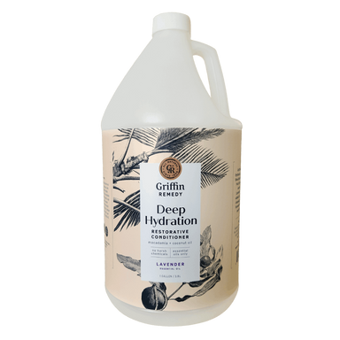A gallon-sized bottle of Griffin Remedy Deep Hydration Restorative Conditioner with a floral pattern on the label. Natural hair care.