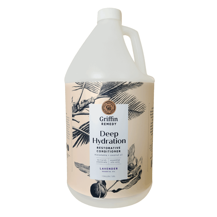 A gallon-sized bottle of Griffin Remedy Deep Hydration Restorative Conditioner with a floral pattern on the label. Natural hair care.
