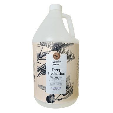 A gallon-sized bottle of Griffin Remedy Deep Hydration Restorative Shampoo with a floral pattern on the label. Natural hair care.