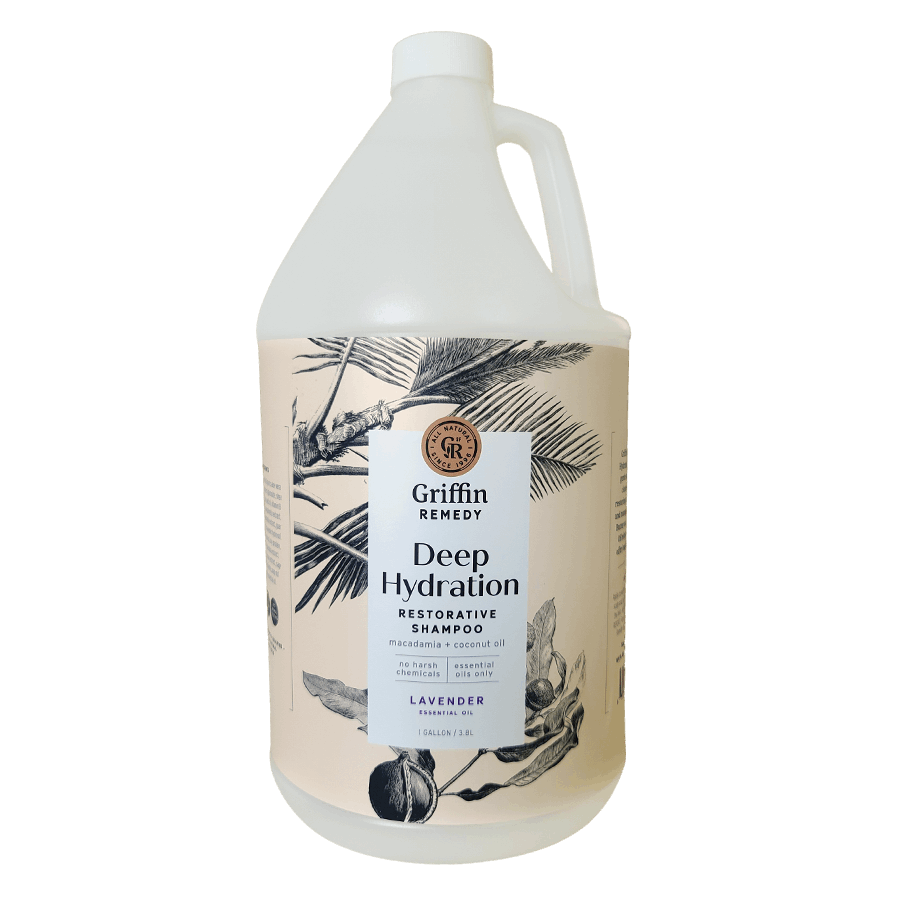 A gallon-sized bottle of Griffin Remedy Deep Hydration Restorative Shampoo with a floral pattern on the label. Natural hair care.