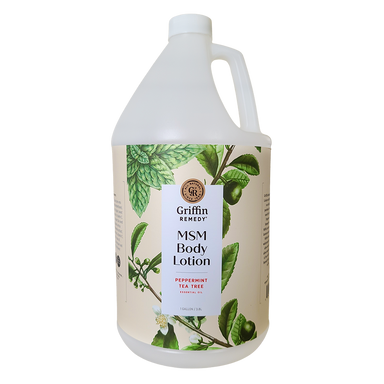 A gallon-sized bottle of Griffin Remedy MSM Body Lotion with Peppermint and Tea Tree essential oils. The bottle is white with a label featuring green botanical illustrations and text. Natural skincare.