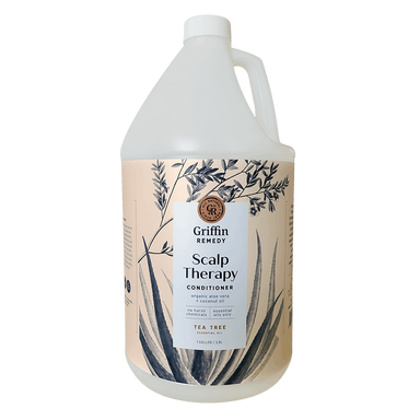 A gallon-sized bottle of Griffin Remedy Scalp Therapy Conditioner with a label featuring botanical illustrations and text indicating Tea Tree as an ingredient. Natural hair care.