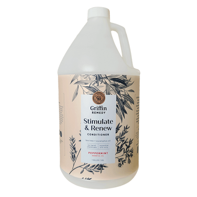 A gallon bottle of Griffin Remedy Stimulate & Renew Conditioner with a label featuring botanical illustrations and text indicating the product name and scent. Natural hair care.
